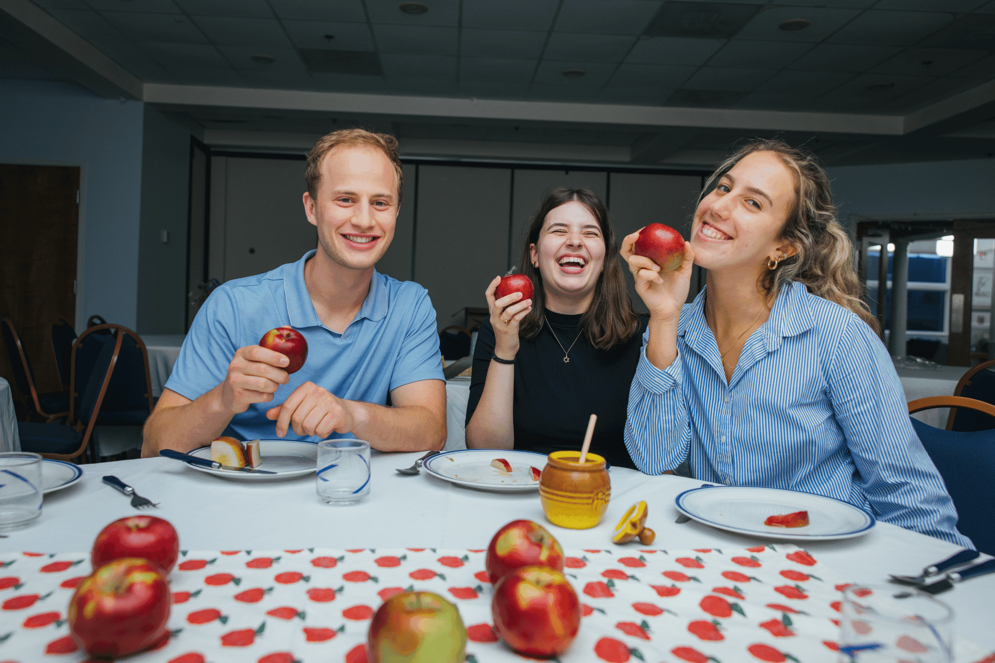 Students smiling with apples and honey