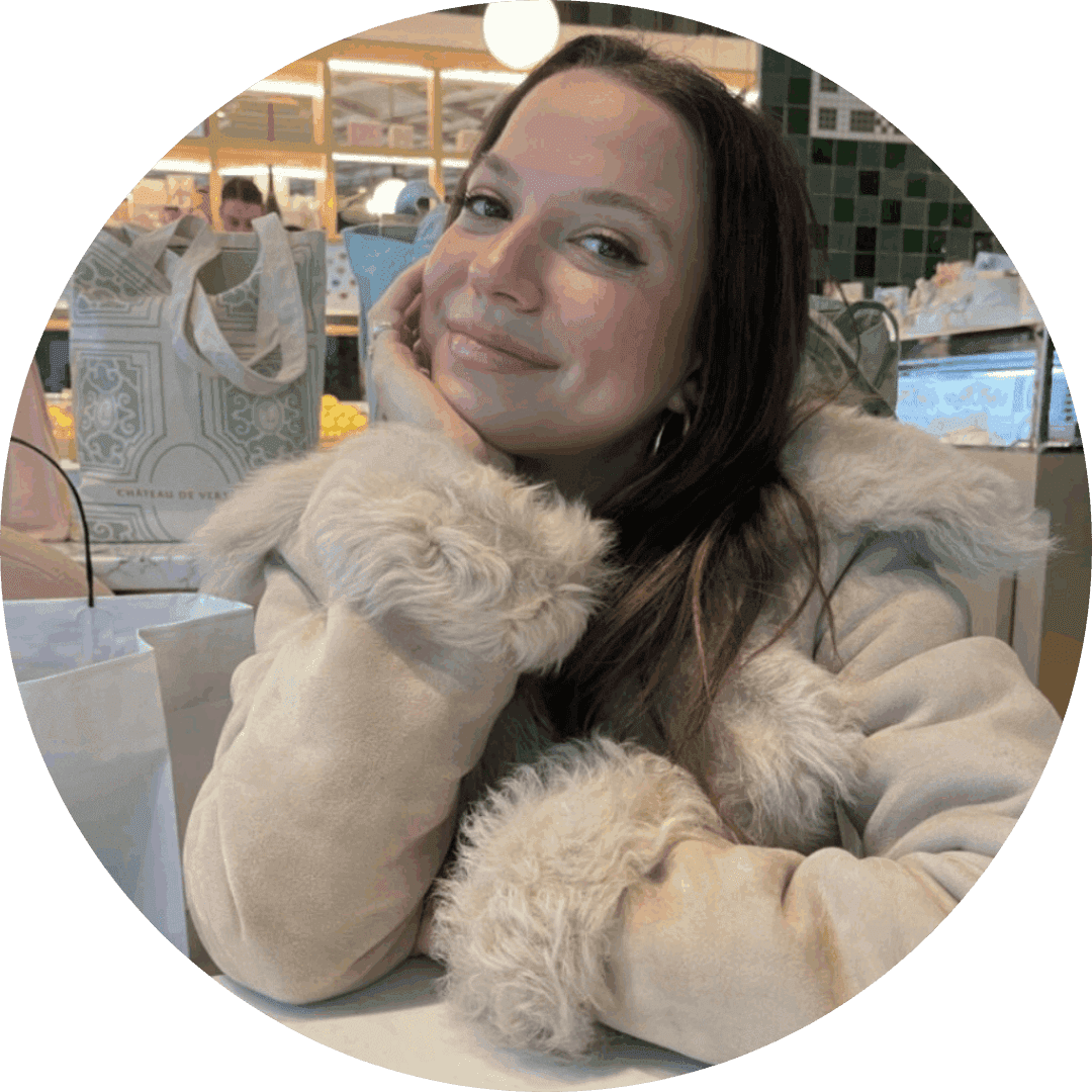 Smiling woman giving a piggyback ride to a laughing young girl.